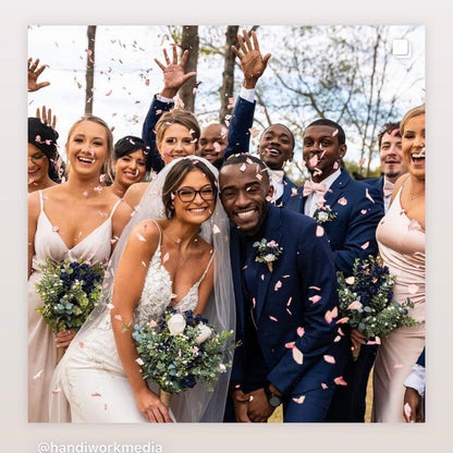 Bulk Blissful Bloom mixed flower petals for weddings and events – Prime Petal Company. Wedding couple surrounded by guests with confetti, smiling and waving.
