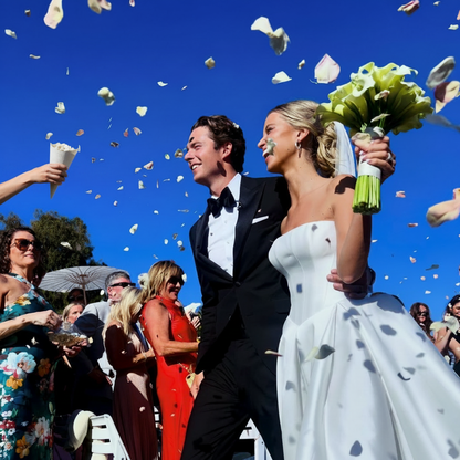 Wedding guests tossing flower petals from seed paper petal cones over bride and groom – Prime Petal Company